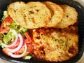 Lasagna with bread and vegetables