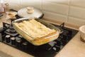 Lasagna extracted from the oven in a glass container Royalty Free Stock Photo