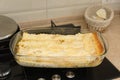 Lasagna extracted from the oven in a glass container Royalty Free Stock Photo