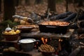 lasagna ingredients arranged around open fire dutch oven