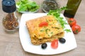 Lasagna with meat, cherry tomatoes, olives and spices on a wooden table Royalty Free Stock Photo