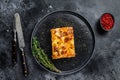 Lasagna with mince beef meat and tomato bolognese sauce on a plate. Black background. Top view Royalty Free Stock Photo