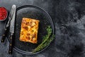 Lasagna with mince beef meat and tomato bolognese sauce on a plate. Black background. Top view. Copy space Royalty Free Stock Photo