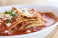 Lasagna. Tasty dish. Red sauce. Blurred Background