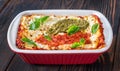 Lasagne topped with tomato sauce and pesto Royalty Free Stock Photo