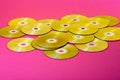 Laser Compact discs on a pink background with color reflection