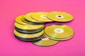Laser Compact discs on a pink background with color reflection