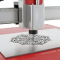 Laser cutter machine engraving intricate mandala pattern on metal plate Royalty Free Stock Photo