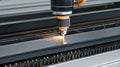 A laser cutting machine in action, creating sparks while processing metal sheets Royalty Free Stock Photo