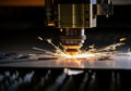 Laser cutting machine creating sparks while processing metal sheet Royalty Free Stock Photo
