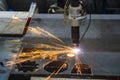 The laser cutting machine cutting the sheet metal plate with the sparkling light.
