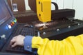 Laser cutting and the operator at the control panel, CNC modern industrial technology Royalty Free Stock Photo