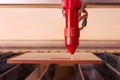 Laser engraver working and engraving flat wooden board Royalty Free Stock Photo