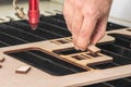 Laser engraver working and engraving wooden board with hand Royalty Free Stock Photo