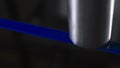 Laser engraves mark on blue wire, closeup