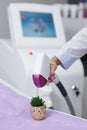 Laser hair removal device. jokingly makes epilation on a green thorny flower