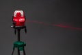 Laser level tool red light beam, grey background Royalty Free Stock Photo