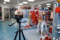 Laser level on tripod in tool store, nobody Royalty Free Stock Photo