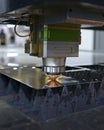 Laser machine cutting metal sheet, sparks coming Royalty Free Stock Photo