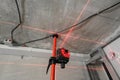 Laser measurement during renovation. Construction tools and equipment. Red laser light lines for level measure. Royalty Free Stock Photo