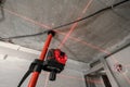 Laser measurement during renovation. Construction tools and equipment. Red laser light lines for level measure. Royalty Free Stock Photo