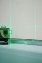 Laser measuring level for construction work, shallow depth of field. Construction laser level at work. Construction and finishing