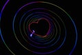 Laser multicolored heart pierced with arrow in circles on black