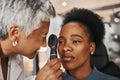 Laser, senior doctor or black woman in eye exam for eyesight at optometrist office. Mature optician helping an African