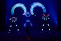 Laser show performance, dancers in led suits with LED lamp, very beautiful night club performance, party Royalty Free Stock Photo