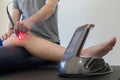 Laser therapy on a knee used to treat pain.