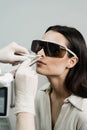 Laser treatment inflammation of the nasal lining, runny nose, sneezing symptoms. Laser treatment of chronic rhinitis Royalty Free Stock Photo