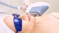 Laser unwanted hair cosmetology procedure. Beautiful young girl. Blue glasses. Face treatment. IPL machine