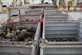 Lashing bins filled with twist locks for securing containers