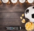 Lasses of beer with snack and soccer ball. Copy space Royalty Free Stock Photo