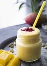 Lassi, traditional Indian drink, commanding with pomegranate seed toppings. Delicious mango and coconut yogurt smoothie with turm