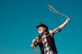 Lasso throwing. Old wild west cowboy with rope. Bearded western man with brown jacket and hat catching horse or cow. Royalty Free Stock Photo