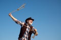 Lasso throwing. Old wild west cowboy with rope. Bearded western man with brown jacket and hat catching horse or cow. Royalty Free Stock Photo