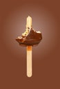 last bit of chocolate outer popsicle on brown background Royalty Free Stock Photo