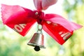 Last call. A bell with a red ribbon. Spring holiday. School years. Graduation. School bells on the background of green