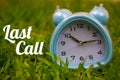 Last Call, Business Concept - text showing Last call with a clock on grass Royalty Free Stock Photo