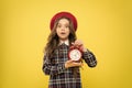 Last chance deadline. Anxious child worried about deadline on yellow background. Stressed little girl holding clock Royalty Free Stock Photo