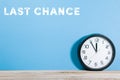 Last chance words on blue colored background with clock Royalty Free Stock Photo