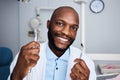 When last did you have your teeth professionally cleaned. Portrait of a young man holding teeth cleaning tools in his Royalty Free Stock Photo