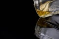 The last drop in the whiskey bottle close up on dark background, Royalty Free Stock Photo