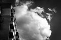 The last floors of a brick multi-story building against the background of a blue sky with white clouds Royalty Free Stock Photo