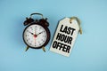 Last Hour Offer text on price tag with alarm clock on blue background Royalty Free Stock Photo