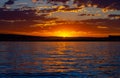 Last LIght Of Day Sun Disappearing Behind a Distant Mountain Range Royalty Free Stock Photo