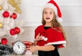 Last minute new years eve plans that are actually lot of fun. Girl kid santa hat costume with clock counting time to new Royalty Free Stock Photo