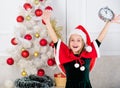 Last minute new years eve plans that are actually lot of fun. New year countdown. Girl kid santa hat costume with clock Royalty Free Stock Photo