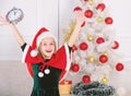 Last minute new years eve plans that are actually lot of fun. New year countdown. Girl kid santa hat costume with clock Royalty Free Stock Photo